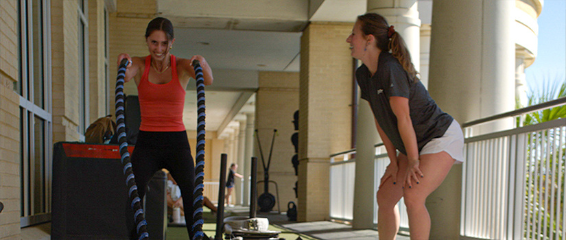 Personal Trainer leading a working out for a fellow student. 