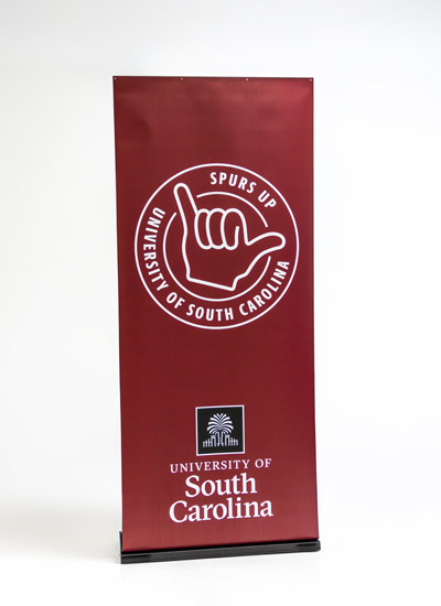 Pop up banner with the USC stamp with text spurs up and the University of South Carolina logo on a garnet background.