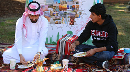 Two students eating at an international student event.