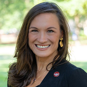 a woman smiling outside in black blazer