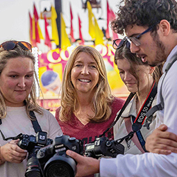 faculty and students holding cameras at the state fair