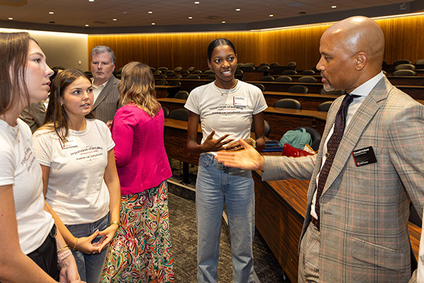 Donald Pollard speaks with students following an event