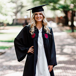 Emily Ruble poses in her cap and gown on the USC Historic Horseshoe.