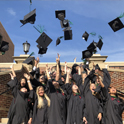 Students toss their caps after graduation