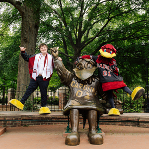 Brayden Hensley and Cocky pose at the Cocky statue at the University of South Carolina